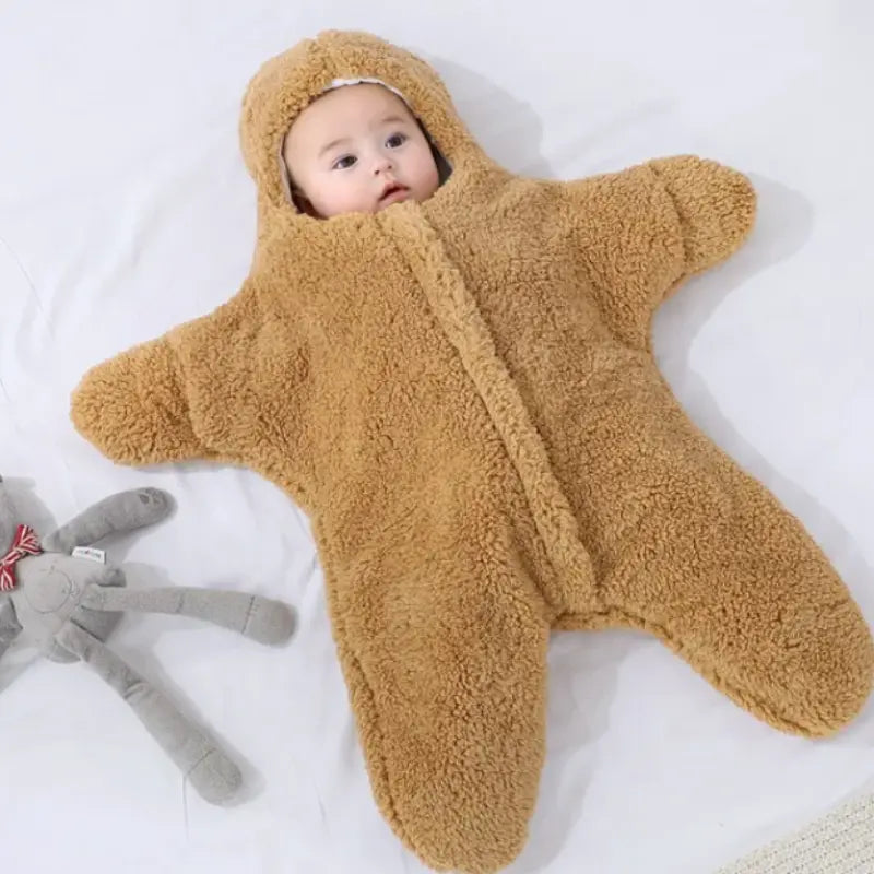 Baby wearing brown fleece starfish hooded sleeping bag