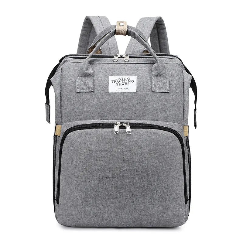 Convertible mommy bag with fold out changing bed
