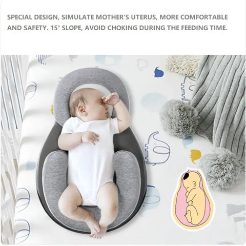 Newborn baby sleeping in grey anti-spit up pillow
