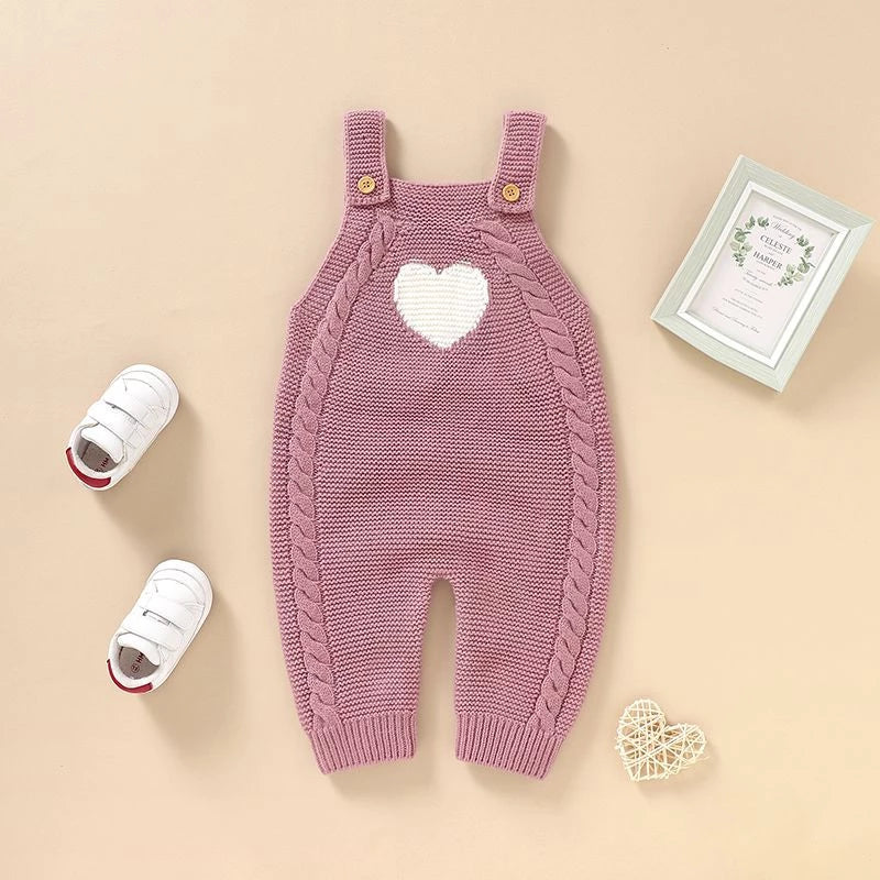Pink knitted baby dungaree romper with heart detail