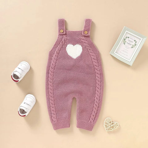 Pink knitted baby dungaree romper with heart detail
